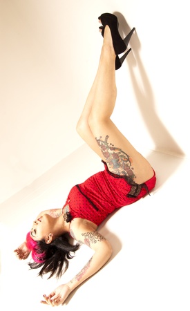 Tattooed Pinup Girl Lying on Floor Legs Upの写真素材