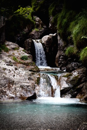 a view of a waterfall in a woodの写真素材