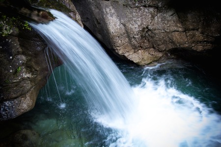 a view of a waterfall in a woodの写真素材