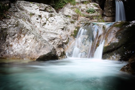 a view of a waterfall in a woodの写真素材