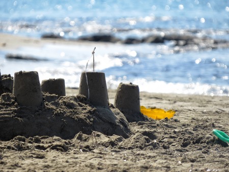 a detail of a sand castle on the beachの写真素材