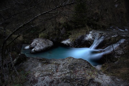 a view of a waterfall in a woodの写真素材