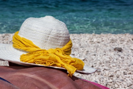 a girl with sun hat that see seaの写真素材