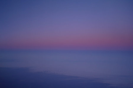 Clouds and blue sky seen from planeの写真素材