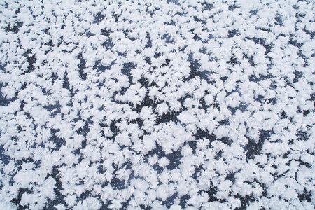 white snowflakes on blue ice