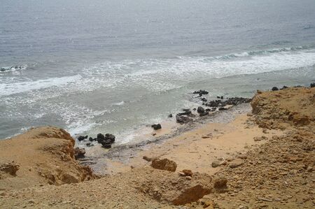 Beautiful azure red sea with waves and rocks and clear blue sky in Egypt.の写真素材