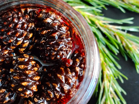 Close up of pine cone jam in a glass jar with pine branch.の写真素材