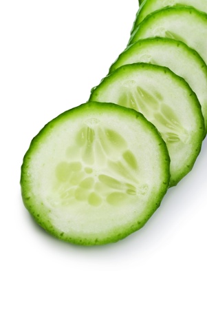   Cucumber and slices isolated over white backgroundの写真素材