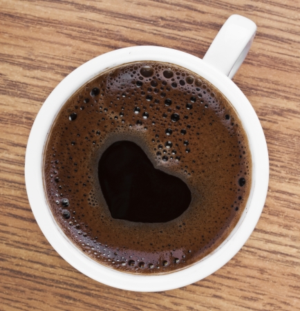 Heart Shape Coffee Foam on The White Glassの写真素材