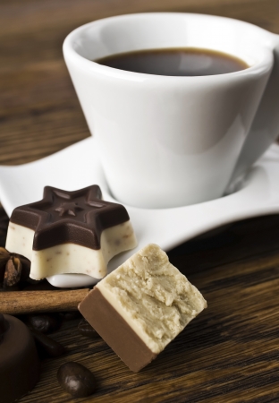 coffee, sweets and spices on an old wooden tableの写真素材