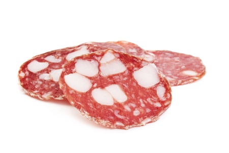 sliced salami isolated on whiteの写真素材