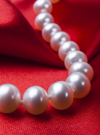 Pearl necklace on luxury satin backgroundの写真素材