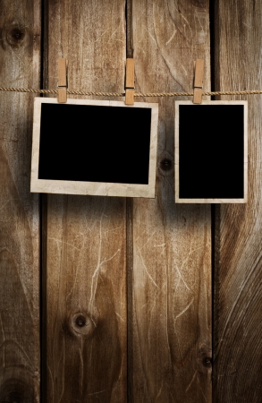Aged photo frames on wood backgroundの写真素材
