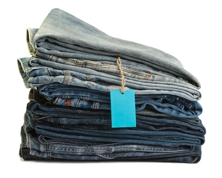 Stack of blue denim clothes on white background, jeansの写真素材