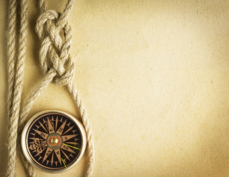 Rope and compass on the old paper backgroundの写真素材