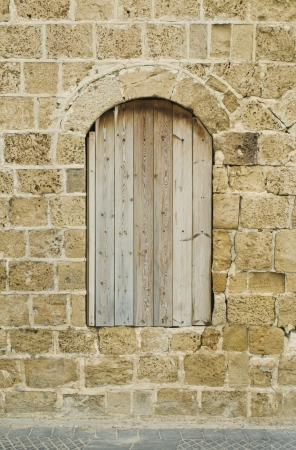 Boarded up window of antique buildingの写真素材