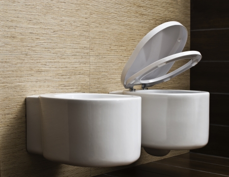 modern toilet with beige tile on wallの写真素材