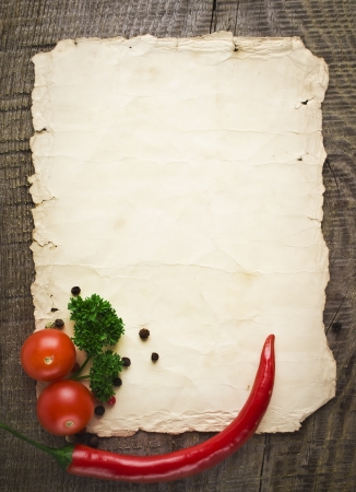 old paper sheet and vegetables for a menu or recipeの写真素材