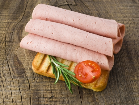Fresh ham slices on the wooden boardの写真素材