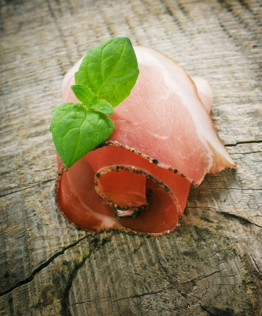 Cured ham on wooden groundの写真素材