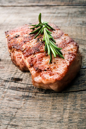 Beef steak on a wooden table の写真素材