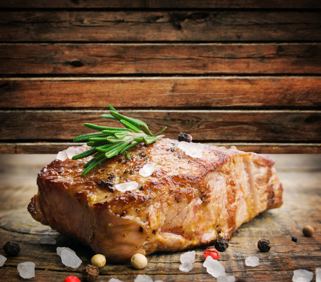 Beef steak on a wooden table の写真素材