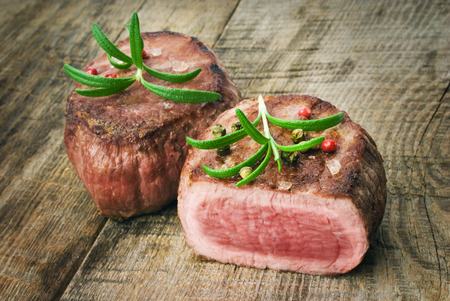 Delicious beef steak on wooden tableの写真素材