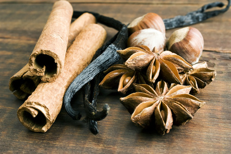 Anise seed, cinnamon and vanilla on grunge wooden plankの写真素材