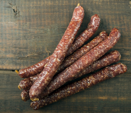 dried sausages on old wooden tableの写真素材
