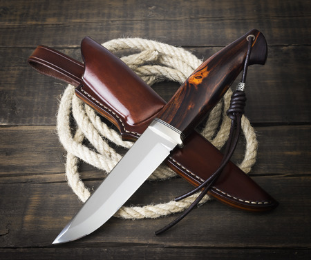 hunting knife handmade on a brown wooden backgroundの写真素材