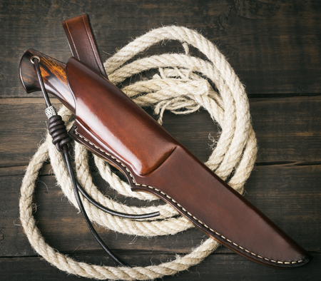 hunting knife handmade on a brown wooden backgroundの写真素材