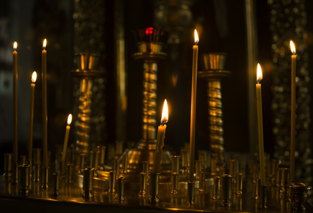 sacred burning candles in the church. Church candles background.の写真素材
