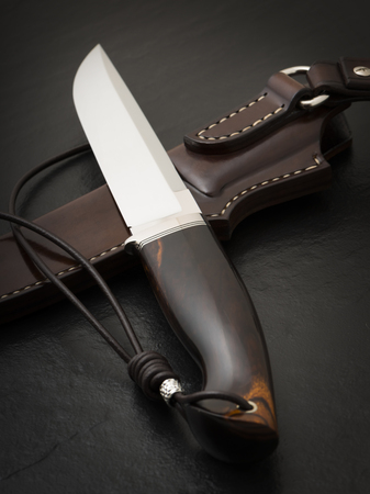 Hunting knife handmade on a black background. Leather Sheath Handmadeの写真素材