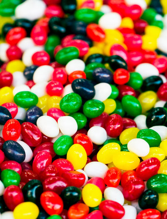 Colorful candies texture background. Rainbow colorful candy coated chocolate pieces in a bowl...