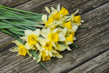 bouquet of fresh spring flowers daffodils on a wooden background. Top viewの写真素材