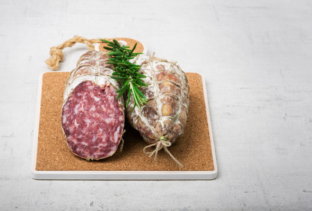 Traditional sausage with mold on wooden board