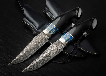 Hunting knife handmade on a black background. Leather Sheath Handmadeの写真素材