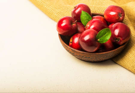 Ripe red apples in a bowl on the table.の写真素材