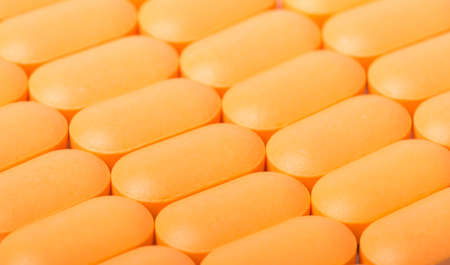 background of orange pills close upの写真素材