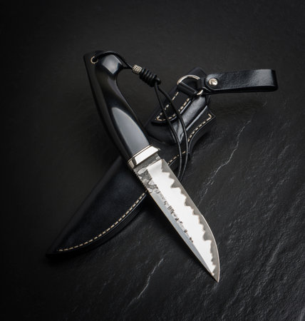 Hunting knife handmade on a black background.の写真素材