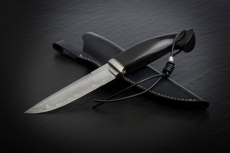 Hunting knife handmade on a black background.の写真素材