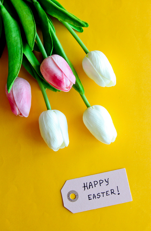 Happy Easter card with tulips on yellow backgroundの写真素材
