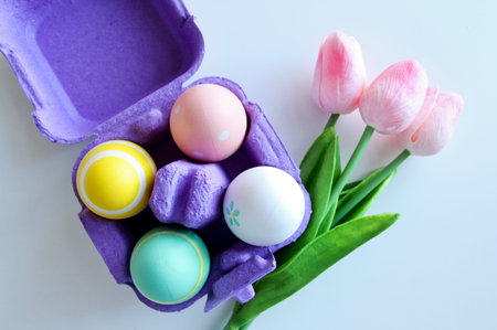 A bouquet of tulips with Easter eggs on a white background