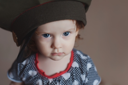 Cute little girl in a soldier s caps の写真素材