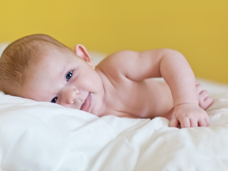 Little baby lie in a bedの写真素材