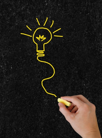 Blackboard. The hand writing with chalk.  Vertical shot.の写真素材