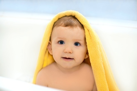 Happy baby in a towel, horizontal shotの写真素材