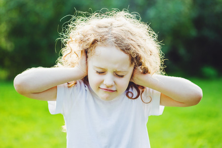 Little girl covering her ears.の写真素材