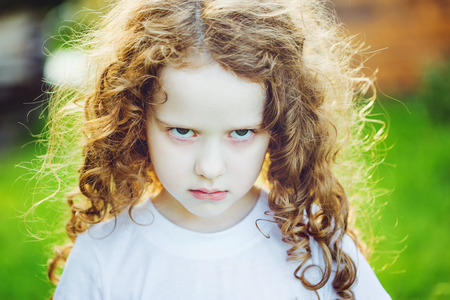 Emotional child with angry expression on face.の写真素材