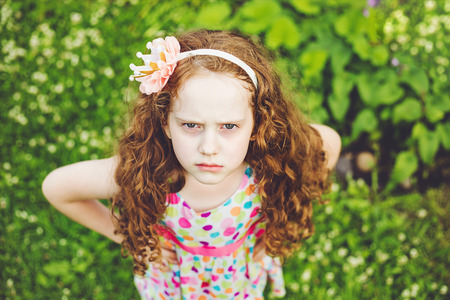 Emotional princess girl with angry expression on face.